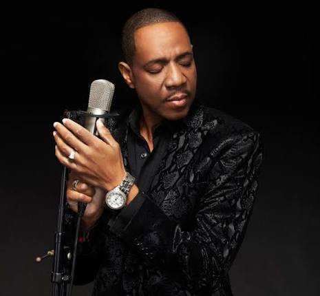 Freddie Jackson holding a vintage microphone
